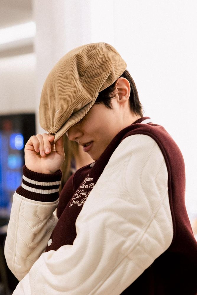 A photo of jhope in an LV letter jacket and a corduroy beret tilted down over his eyes looking like the coolest human in the universe. 