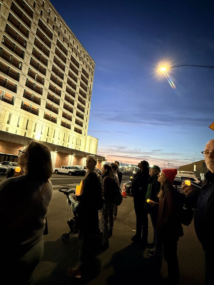 People holding candles outside MDC 