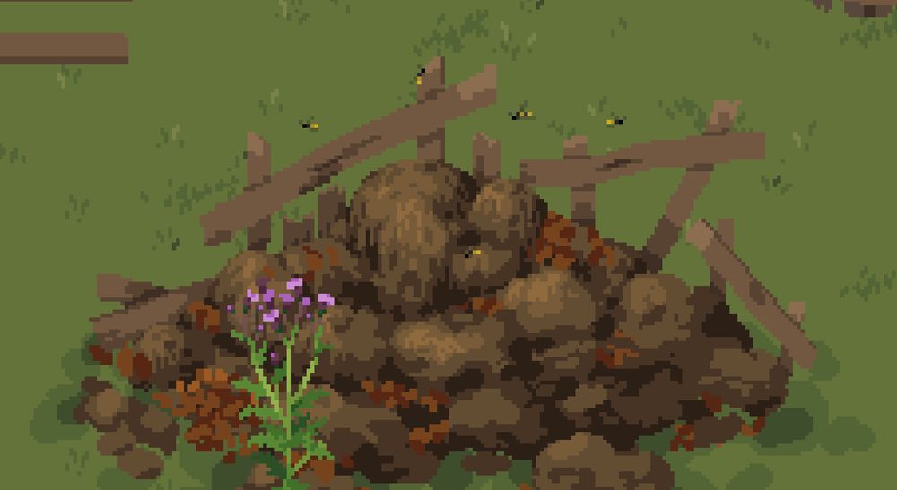 A dirt brown compost heap with some dark brown leaves piled against a broken wooden fence. Small wasps are seen flying above the heap itself. On the foreground a purple flower is blooming.