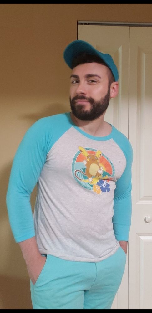 Jean in a very casual cosplay of a Pokémon trainer featuring Alolan Raichu on his shirt
