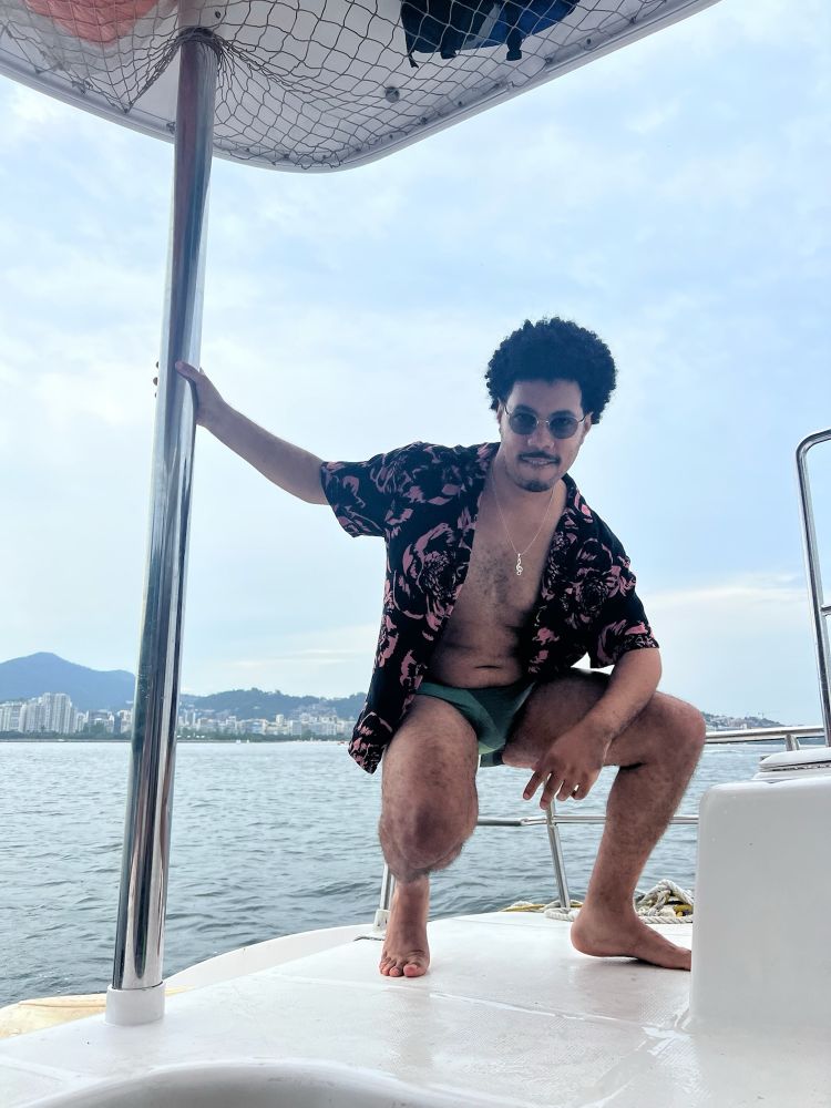 beautiful boy on a boat with his legs & meat out