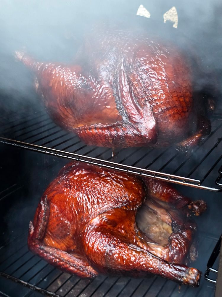 Two turkeys in the smoker! Deep brown-ish red skin from the maple wood smoke.