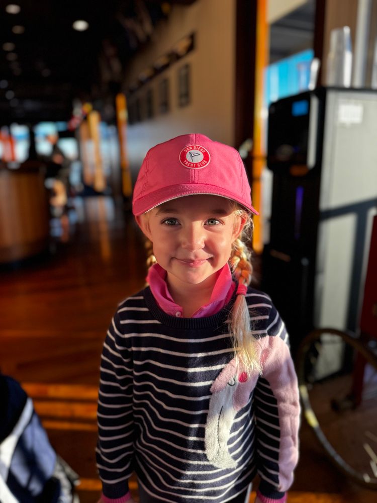 Surfin_Daughter smiling for the camera. The sunlight is falling across her and she's looking super cute.