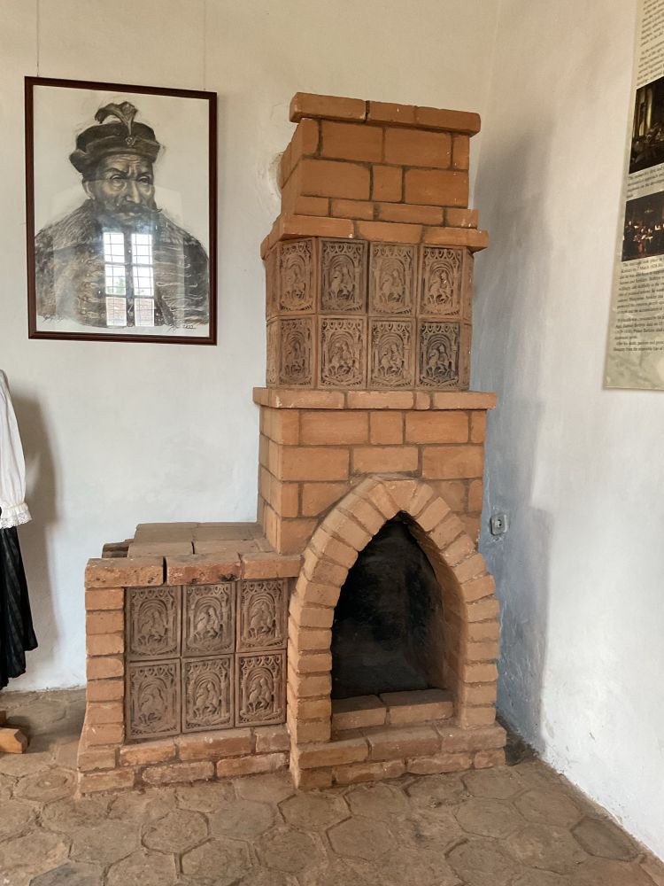 Old brick fire place with the lord’s picture on the wall beside it 