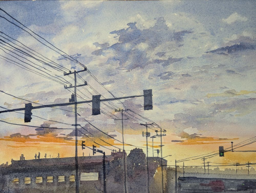 Watercolor painting of a sunset, with streetlights and buildings silhouetted in the foreground. 