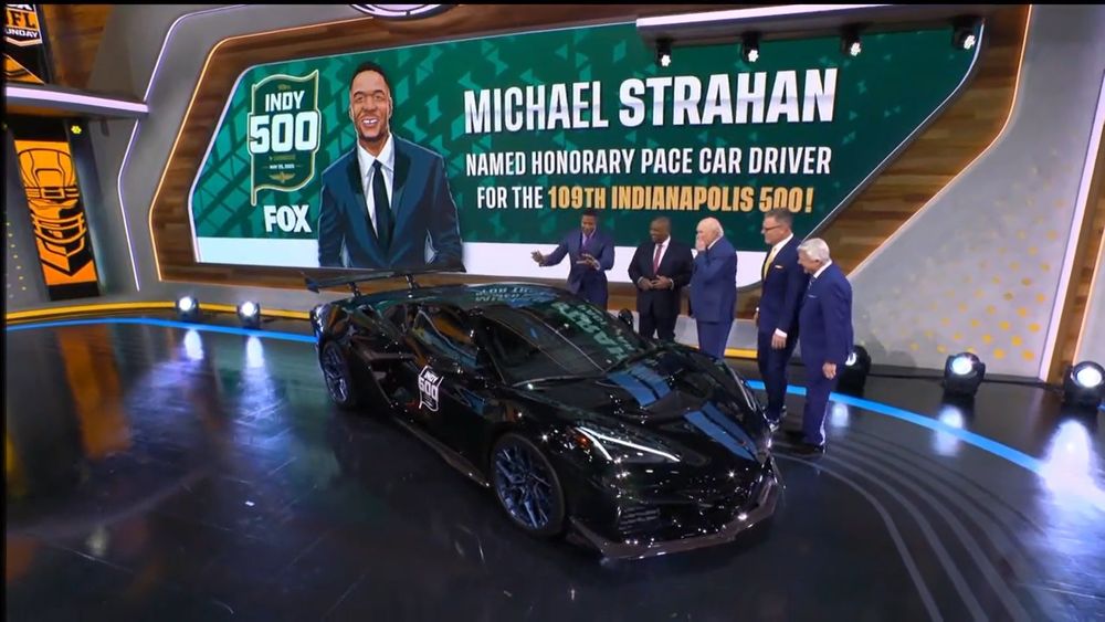 Photo of the NFL Studio where Michael Strahan was announced as the Honourary Pace Car driver for the Indianapolis 500. The presenters are standing in front of a modified black Chevrolet Corvette pace car Strahan will be driving. 