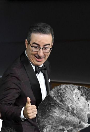 John Oliver in a tux gives a thumbs up to a black and white photo of a brachiopod.