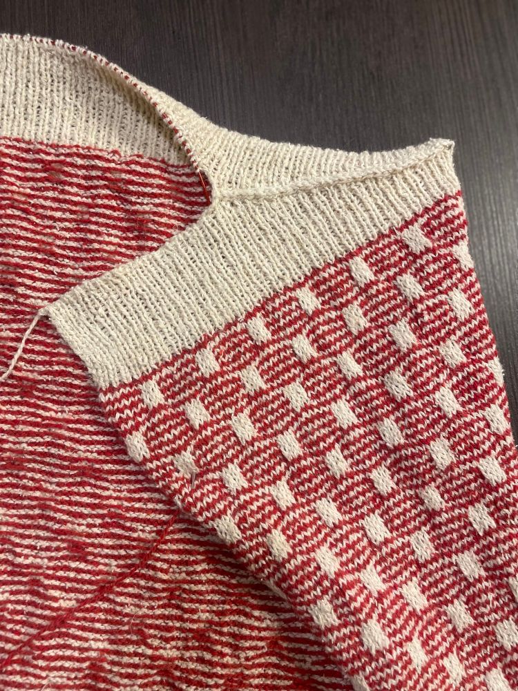 Progress photo: three needle bind off and tubular bind off of shoulder and collar.