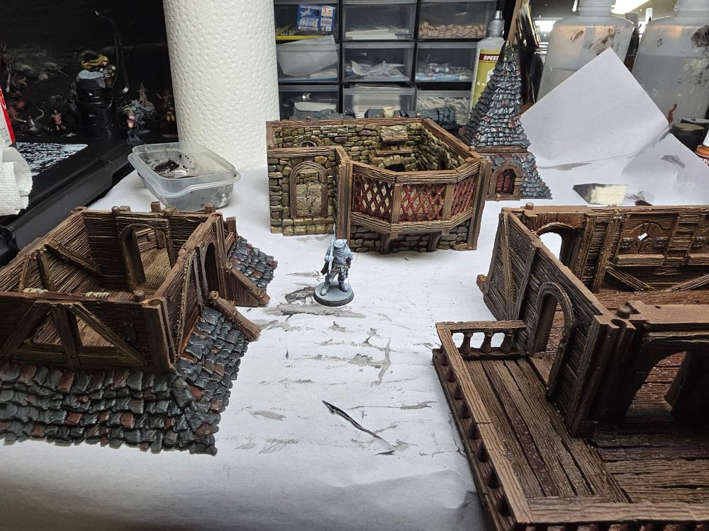 The same building disassembled into levels with a Trench Crusade mini for scale