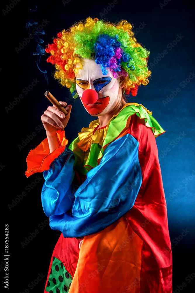 annoyed looking clown holding a cigar