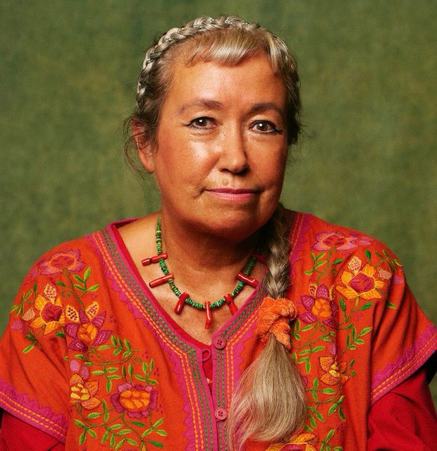 The poet Pascale Petit looking fabulous in a red floral top and matching beads 