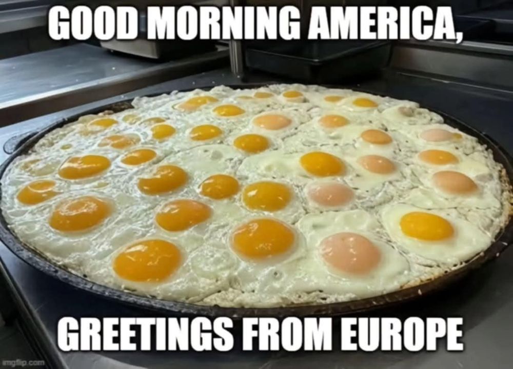 A frying pan loaded with about 30 eggs easy over