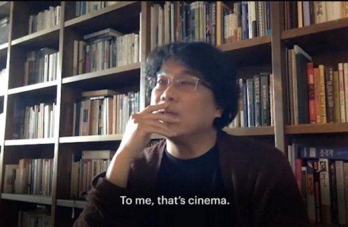 Bong Joon-ho, hand to face, in a library saying "To me, that's cinema."