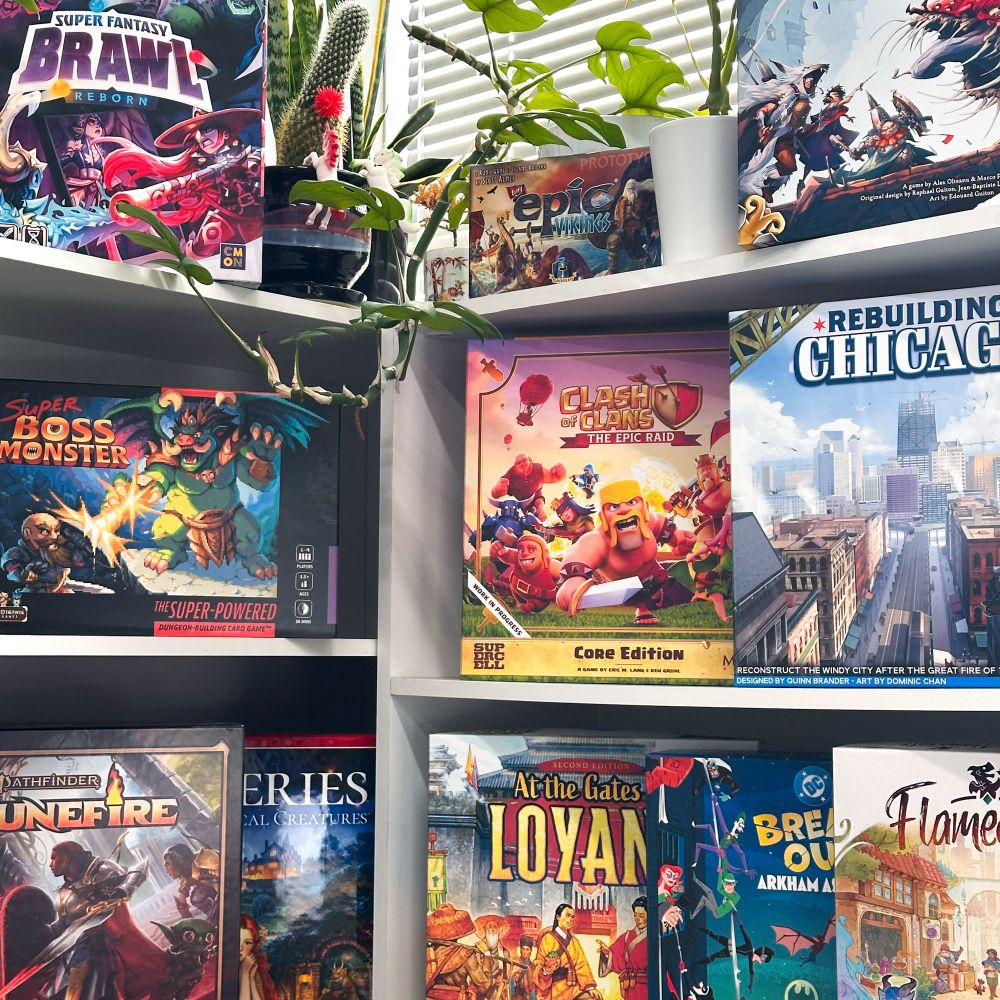 Tons of colorful game prototype boxes lined up on our display shelves 