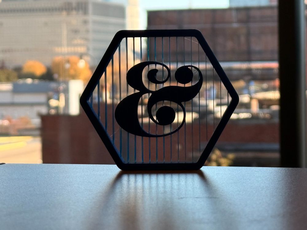 Suspended 3D print of ampersand.