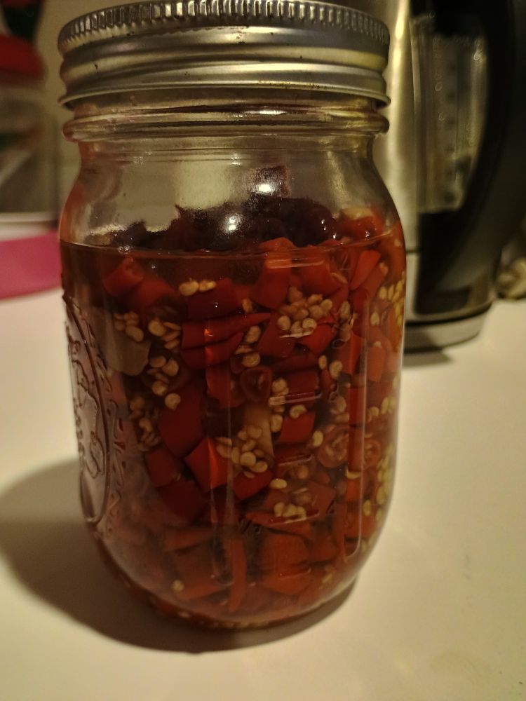 a big jar of pickled thai chilies