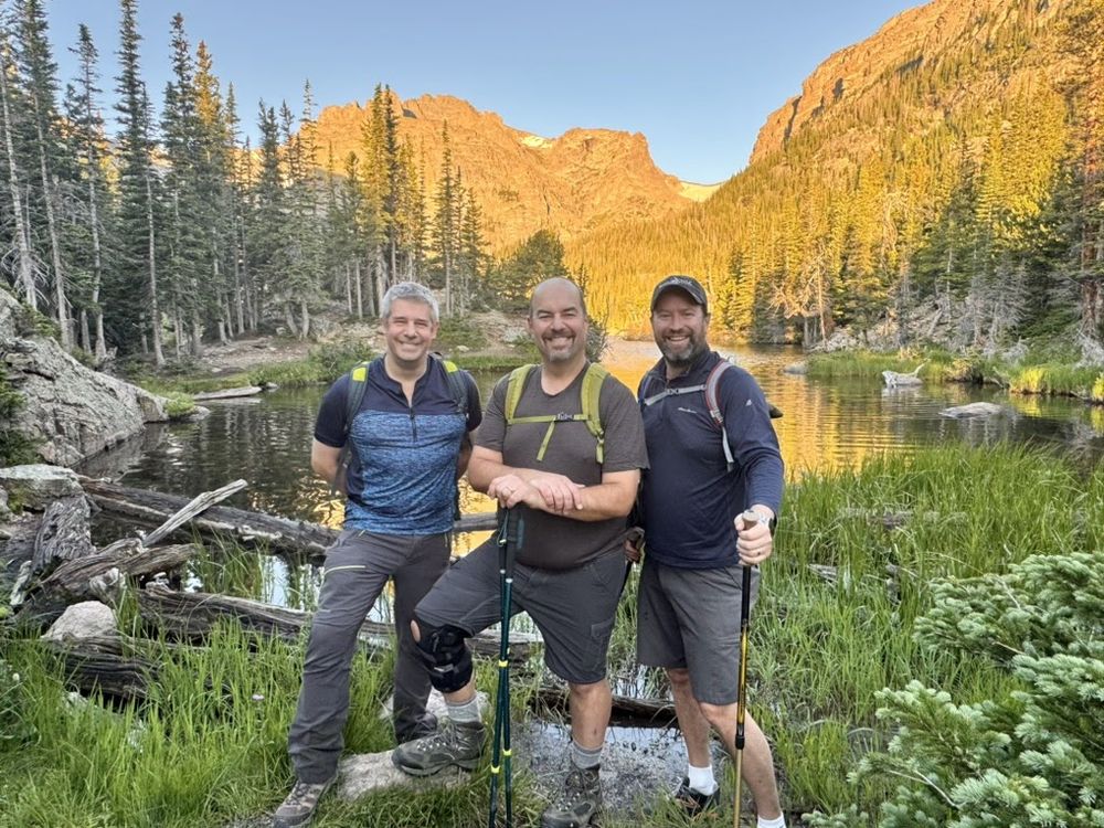 Stephan, Paul, and Kevin in front of the Loch in the sunrise