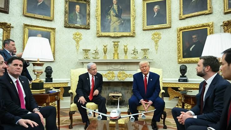 Trump's oval office

The greenery is gone.

A extra decorative marble panel with gold inlay has been added to the fireplace surround. The mantlepiece has 7 gilt silver pieces atop it, flanked by two decorative gold scones on the wall wither side.

No less than 11 gold framed portraits are visible across the walls, with the strong suggestion there are more all across the walls. 