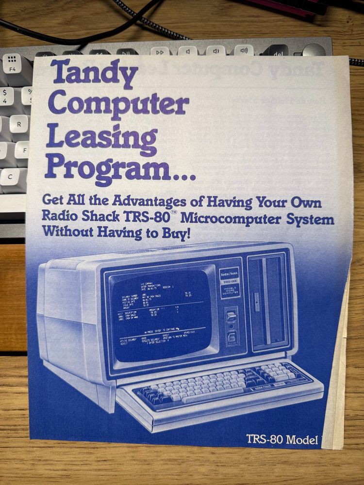 Front page of a pamphlet with a Tandy TRS 80 Model II computer.