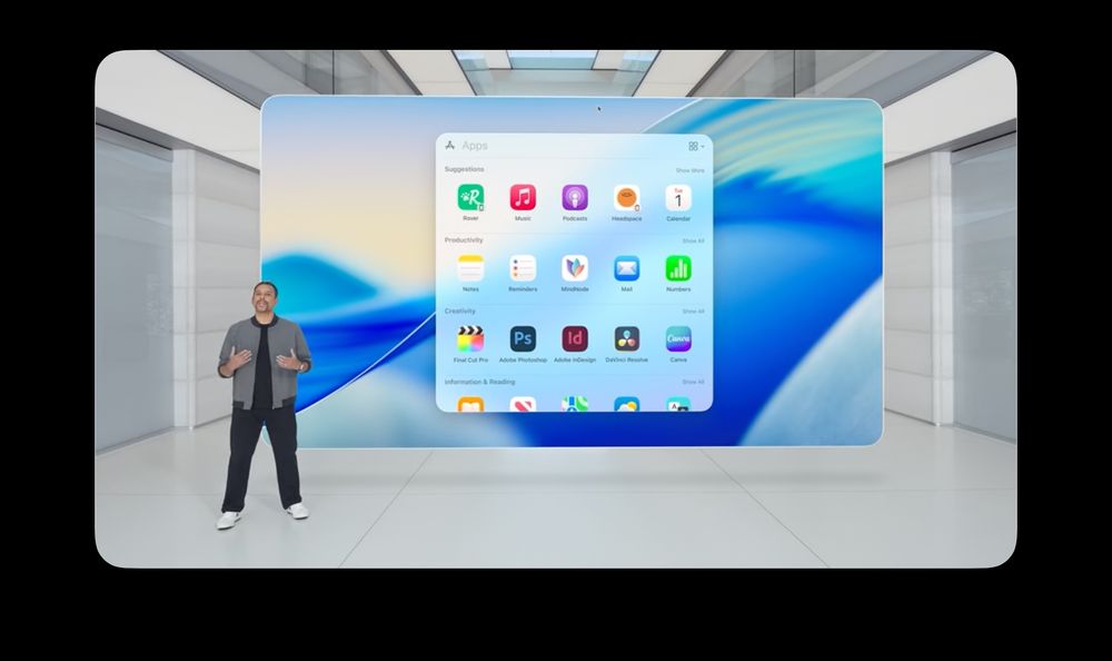 Screen capture from the Apple WWDC 2025 keynote. Person standing in-front of a slide. Slide showing a screenshot of the Spotlight Window with the MindNode logo in the center.