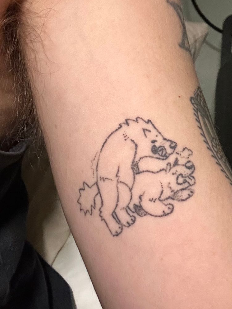 handpoke tattoo of two dogs goin’ at it. they’re both boys 