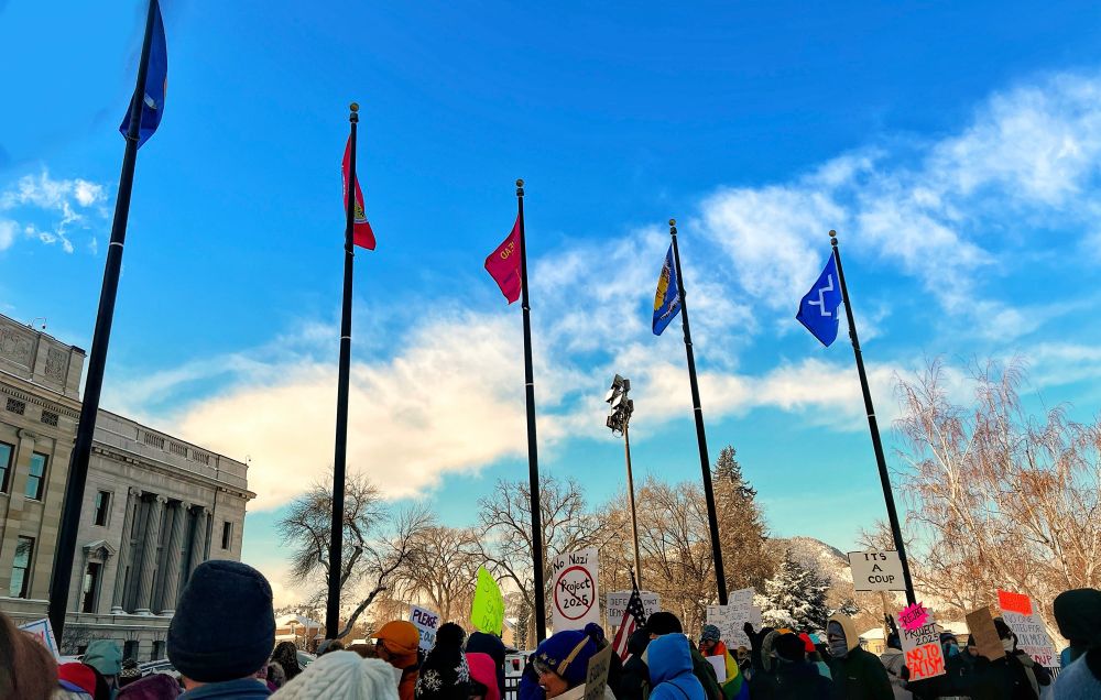 A small group of protesters gathers on the front steps of the Montana State Capitol in Helena. 
