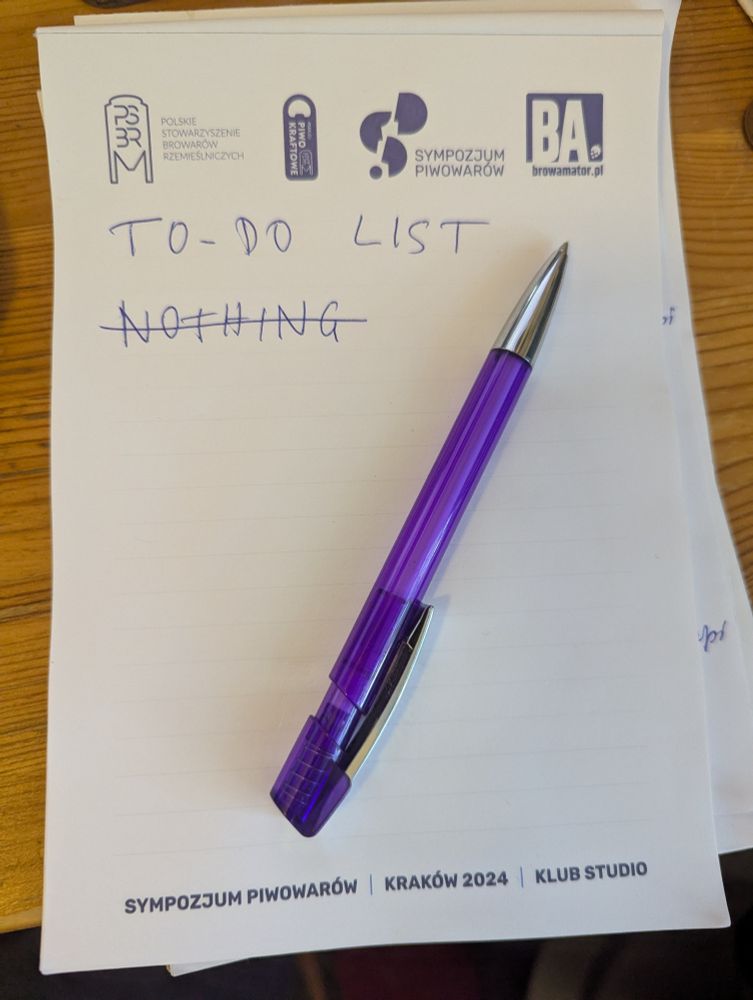 A notepad with a ballpoint pen lying on it.

The notepad has "TO-DO LIST" handwritten on it and "NOTHING" underneath which is struck through, akin to the SpongeBob to-do list meme. It is also Sympozjum Piwowarów 2024 branded, which is the event where I was given it for free.