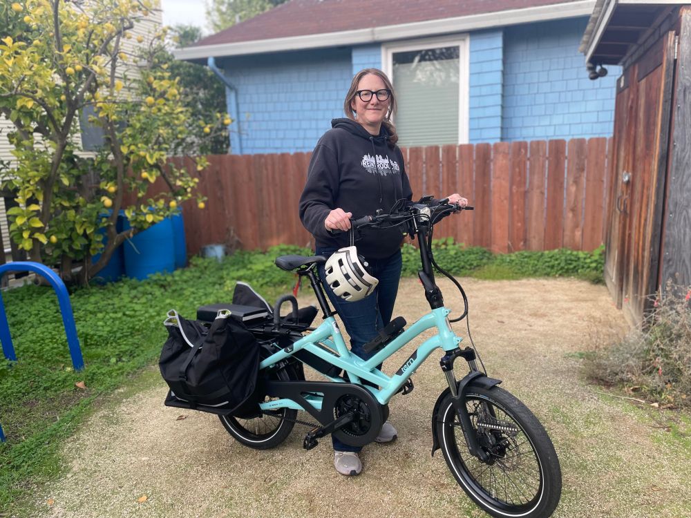 Me, standing outside our house with my new mint-colored Tern HSD