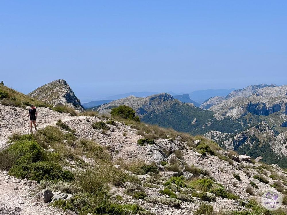 A photo of the Mallorcan Tramuntana mountains including a hiker, approaching the camera.
