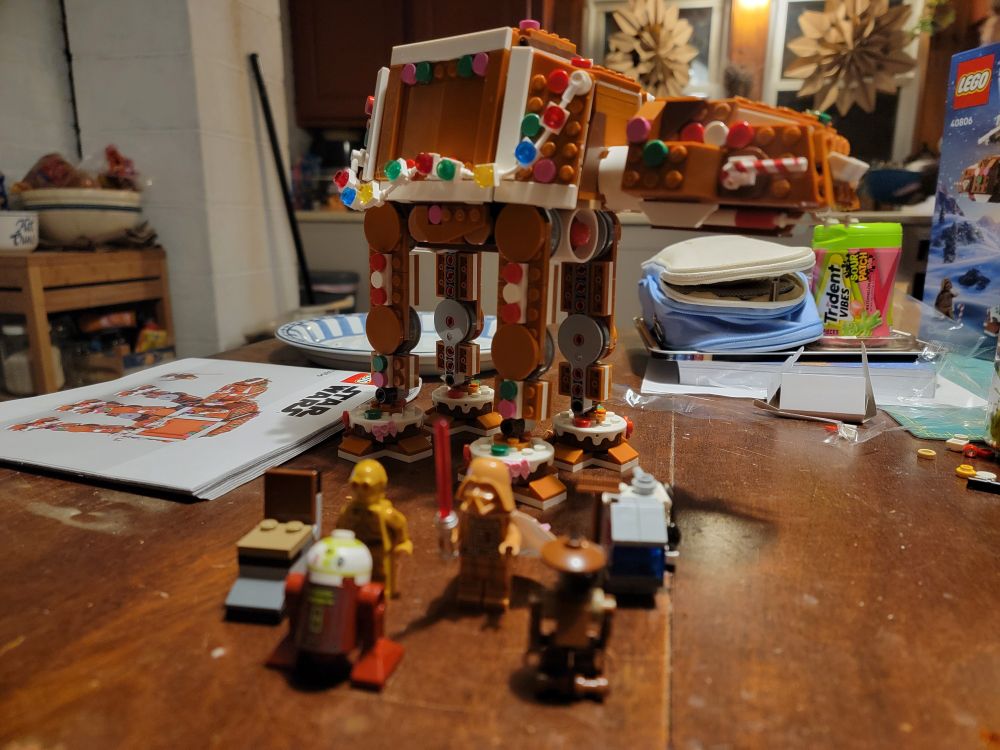 Completed gingerbread AT AT with gingerbread Darth and other minifigs.