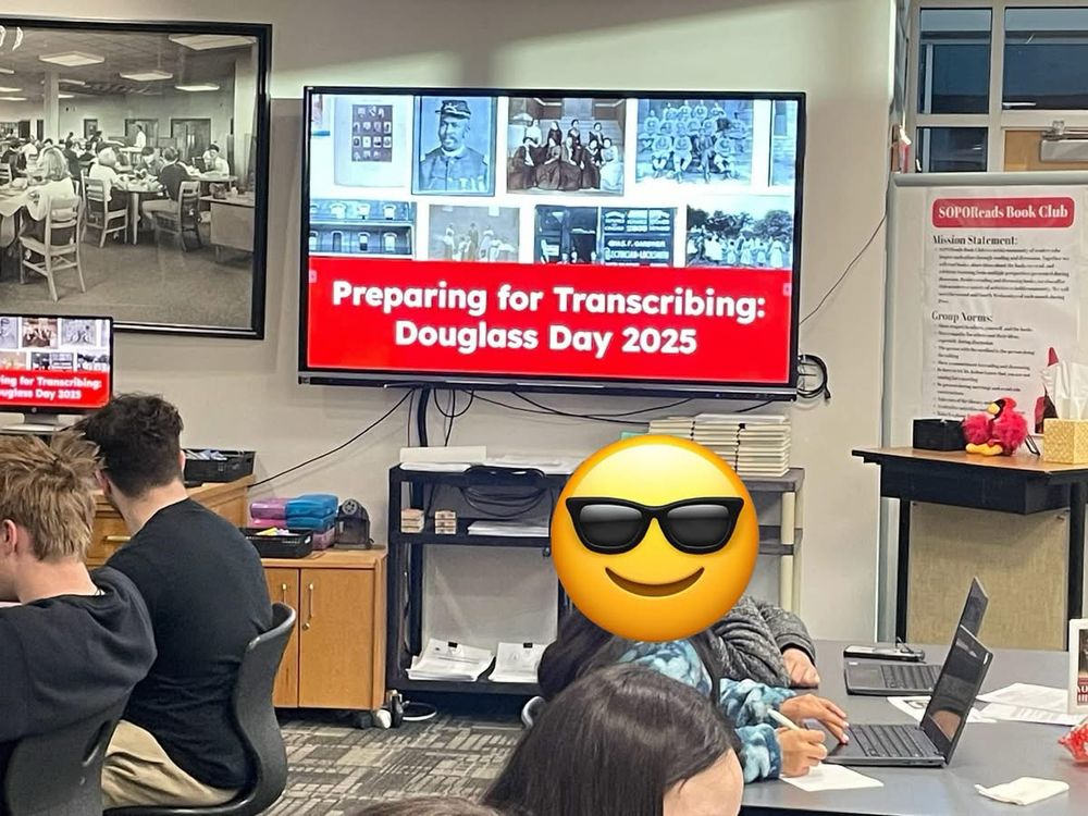 Students using computers to transcribe historical documents. 