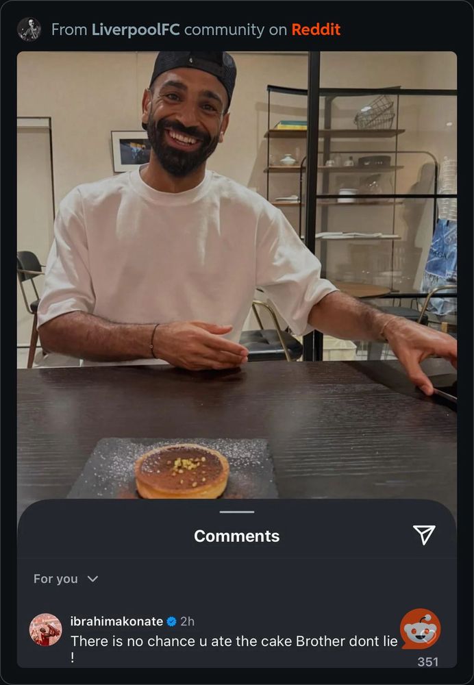 Egyptian King Mo Salah sitting in front of a teeny tiny crème brûlée looking cake and his teammate Ibrahim Konate aka Ibou making the joke about him not eating cake 