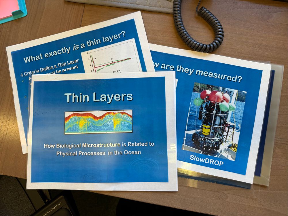 A set of color transparency sheets of slides for a presentation on thin layers sit on a desk in my office. 