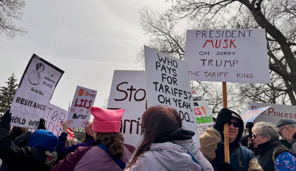 Photo from the April, 5th Hands Off protest in Waterloo, Iowa. Attendees holding signs criticizing the administration. 