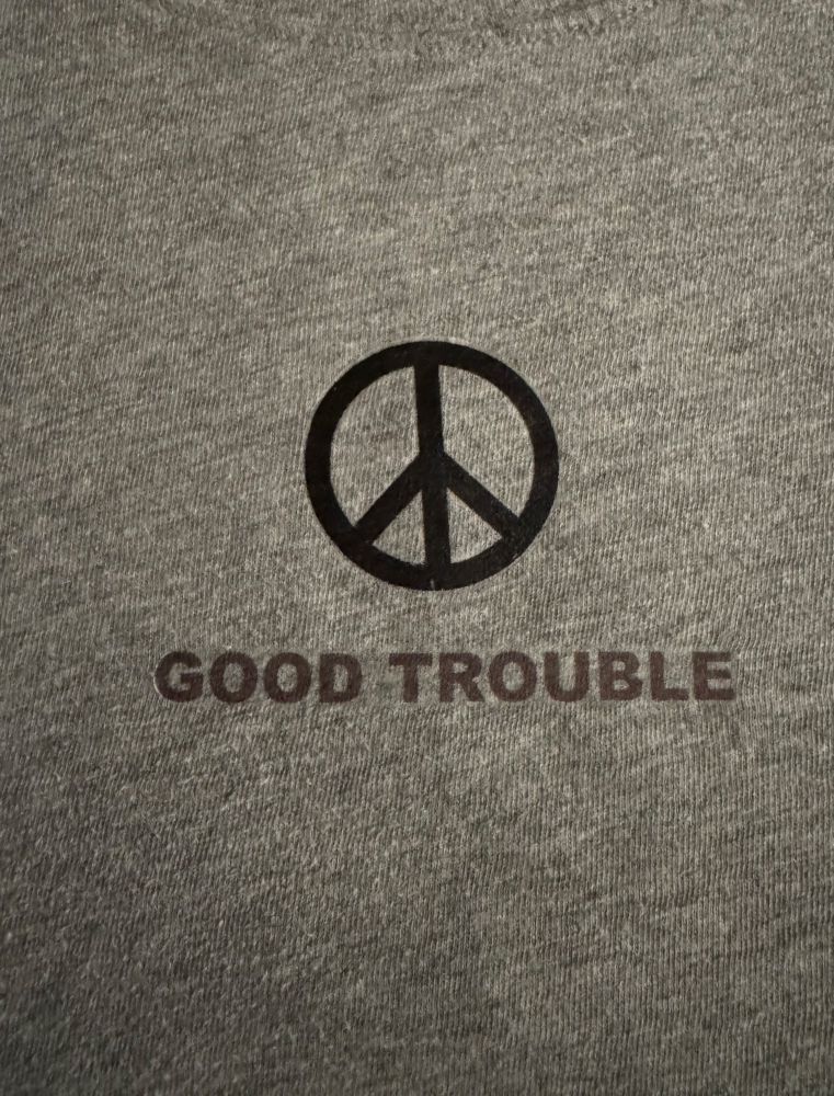 T Shirt with peace sign and “good trouble”