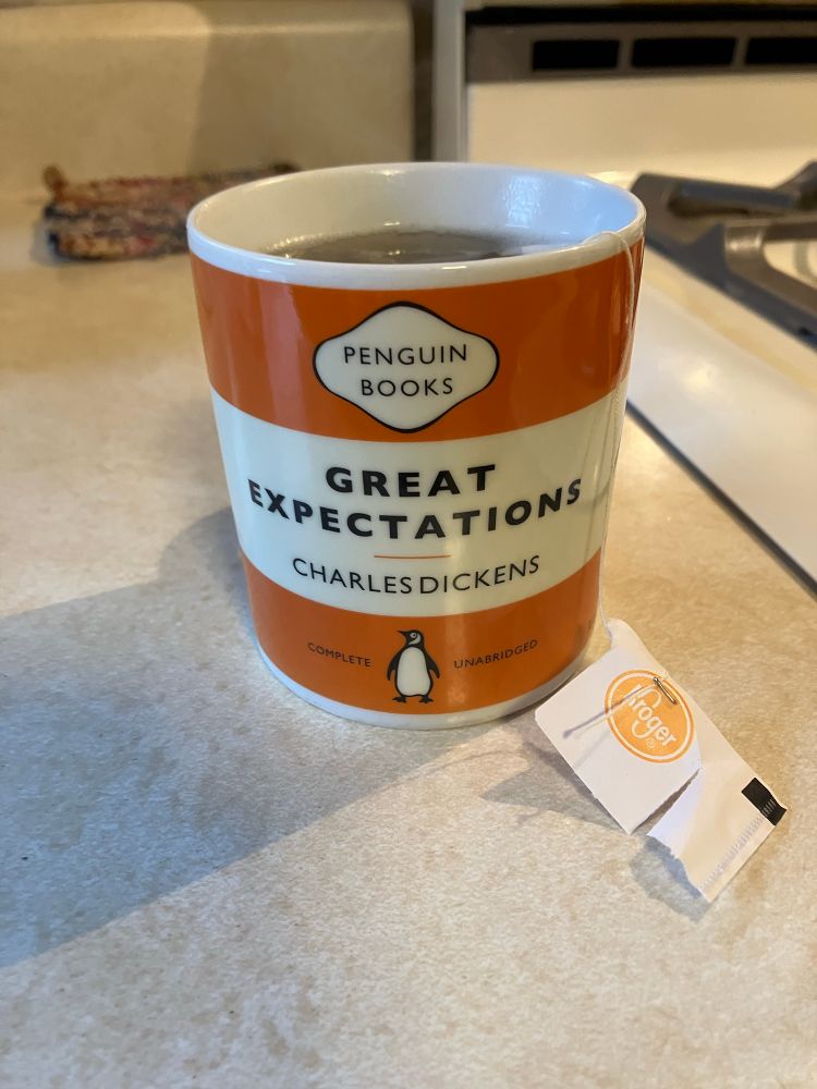 AheadByEcho’s coffee mug reading Great Expectations by Charles Dickens.