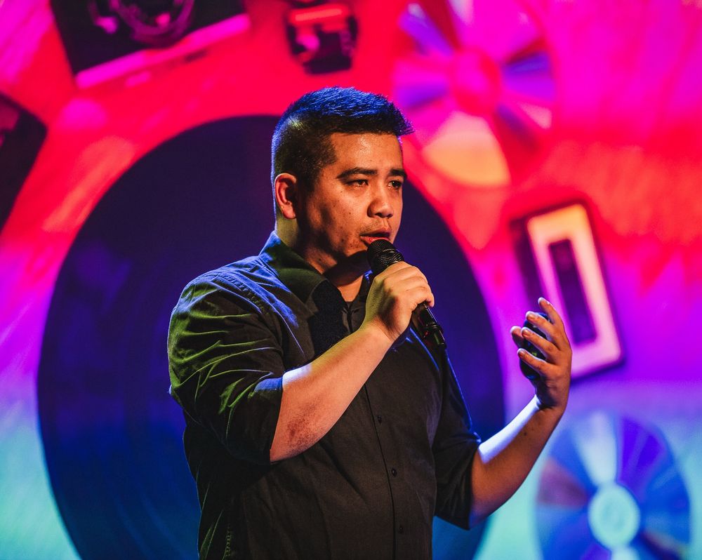 Quang DX giving a speech on stage at the Debug Indie Game Awards 2025