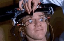 Classic image from A Clockwork Orange showing the main character with his eyes held open, being forced to watch a film