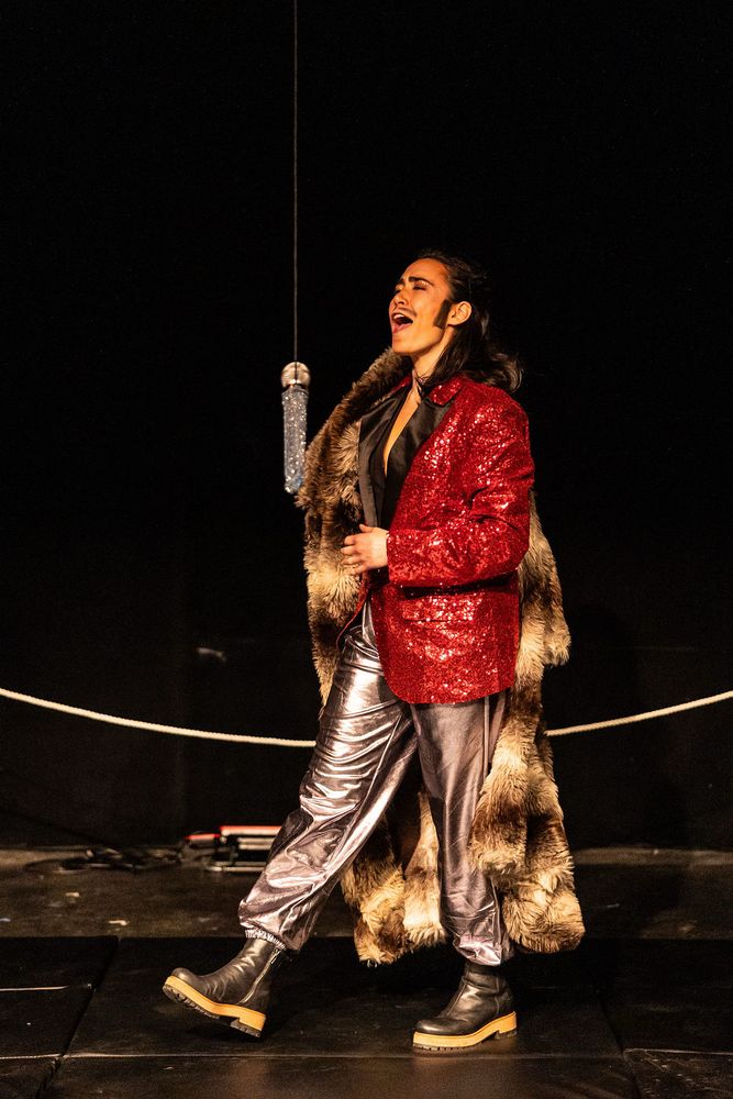 Vinny MacMan, a drag king wrestling mogul greets the crowd. 