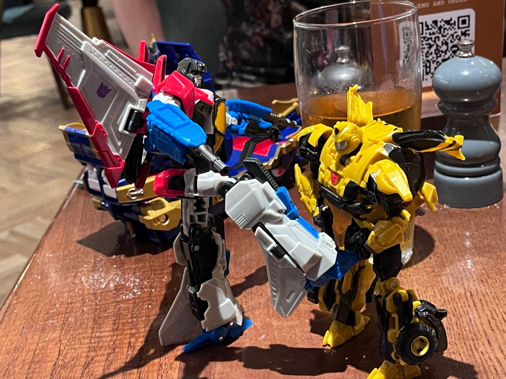 Playing with Transformers toys. Reactivate Starscream kicks Reactivate Bumblebee in the oil change.