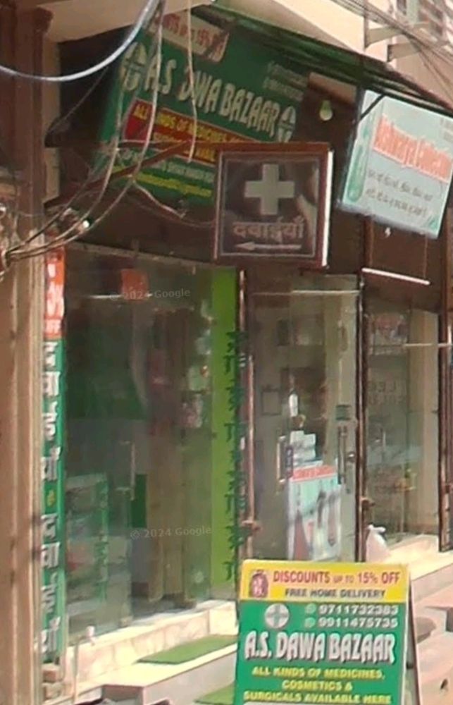 A pharmacy in Delhi called A. S. DAWA BAZAAR. The font on both the shop sign and sandwich board outside the shop is Revue (aka Afterburner/Mortal Kombat font)
