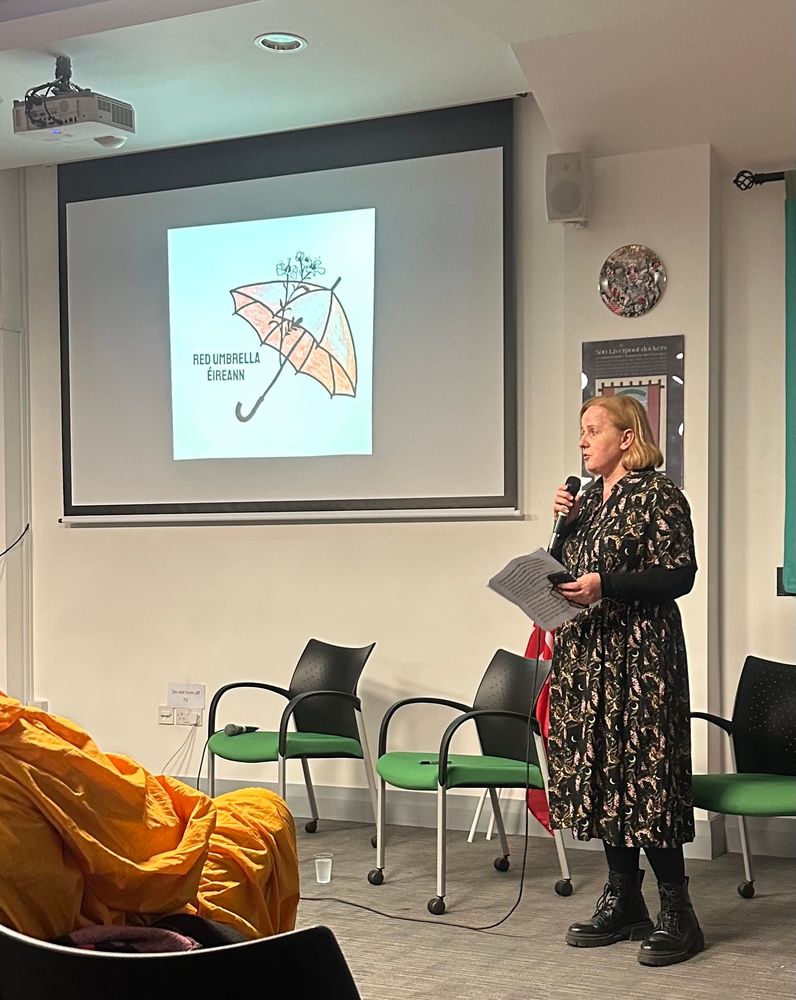 Ruth Coppinger TD speaking in front of a Red Umbrella Éireann backdrop