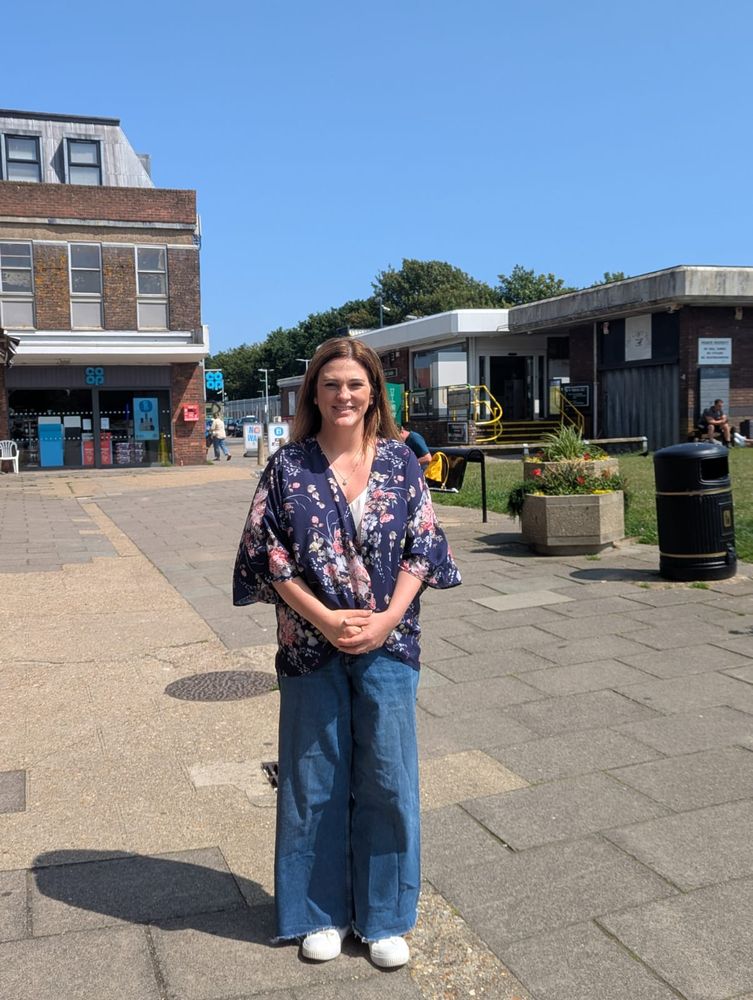 Sarah Whitehead, casually dressed, in a shopping precinct on a sunny day.