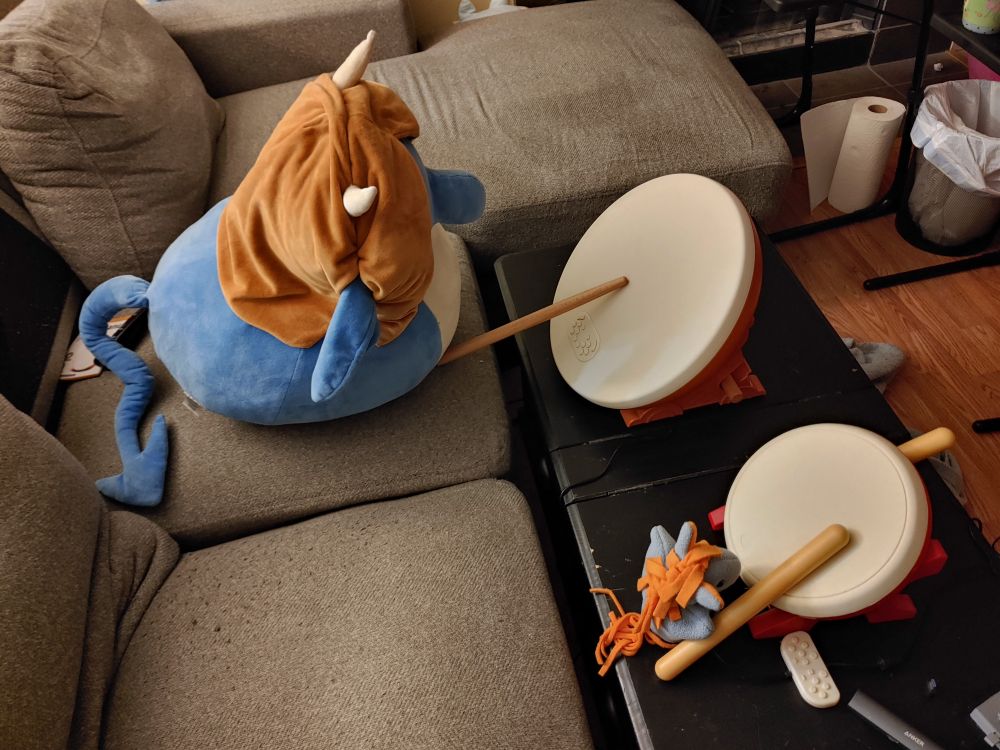 The creature, and another, smaller creature, playing a toy drums