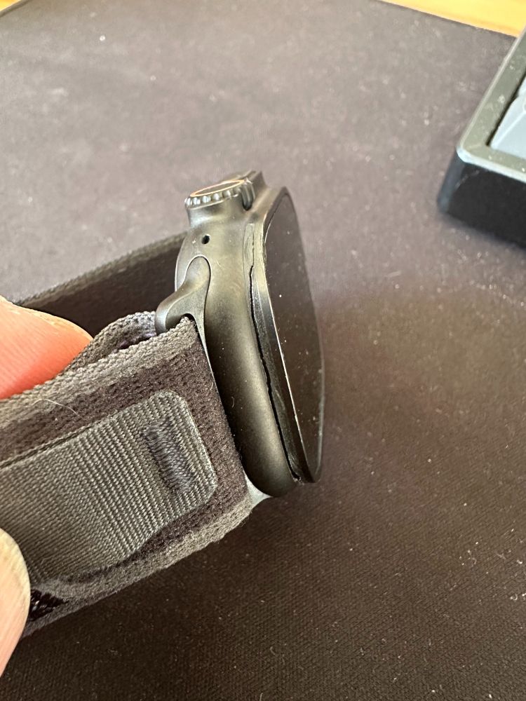 Photo of an Apple Watch Ultra 2 in black with a crack between the body and the screen.