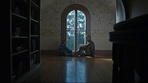 A father and son, sitting in front of a window.