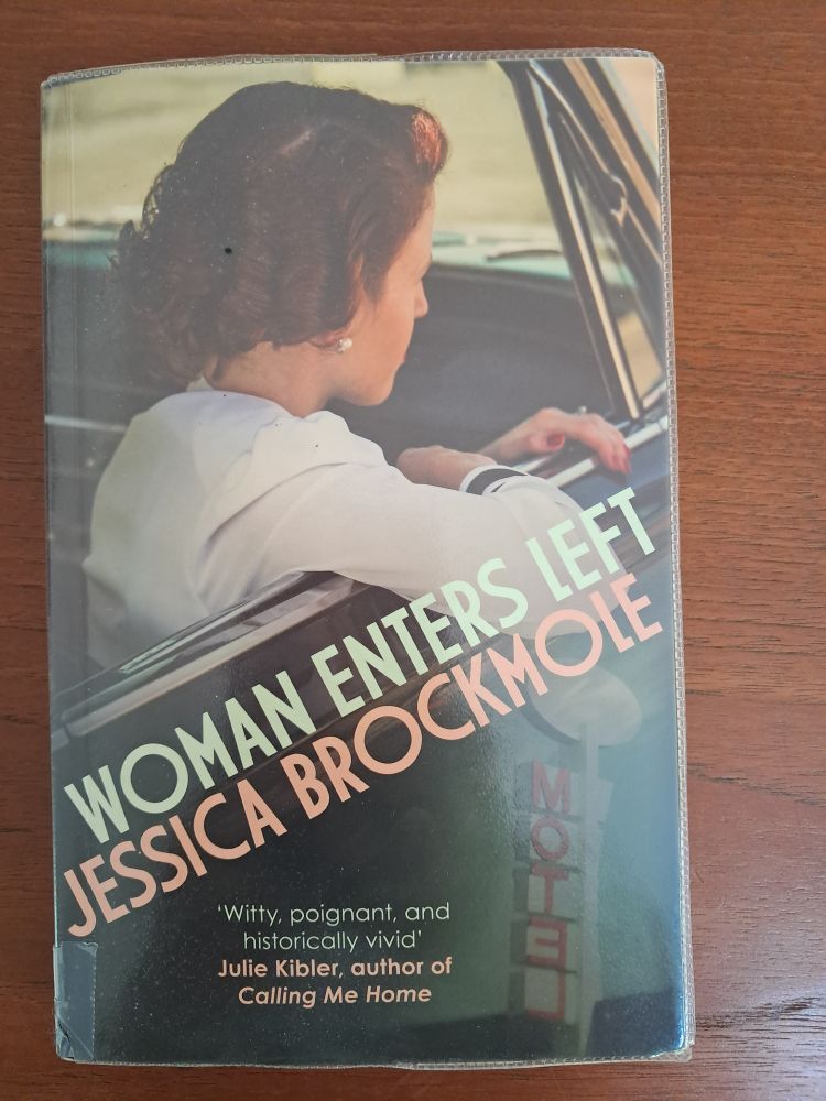 The paperback edition. The cover shows a  woman in a car looking away from the viewer. 
