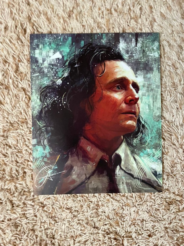 An art print from Loki--Loki (Tom Hiddleston) is wearing his TVA button-down shirt and tie. He's staring off into the distance with a serious, emotional look in his eyes.