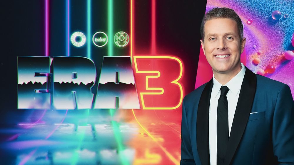 Uma imagem que diz "Era 3", com o logo dos canais overloadr, jogabilidade e nautilus, e uma foto de um homem de terno sorrindo na direita da imagem (geoff keighley, o host do summer games fest)