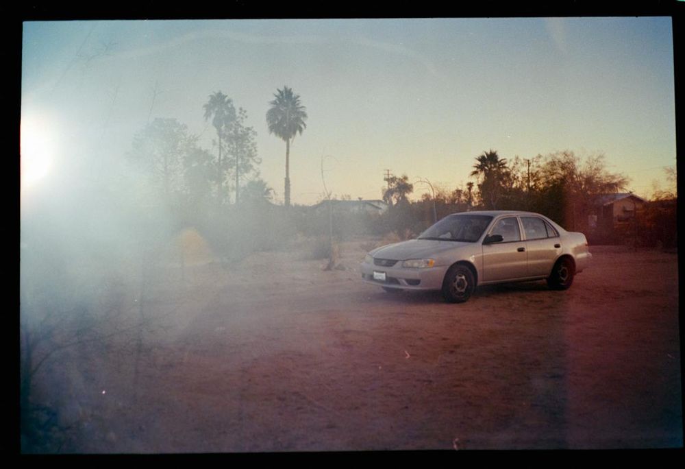 Film photography of a 2002 Toyota Corolla taken at Joshua Tree during sunset